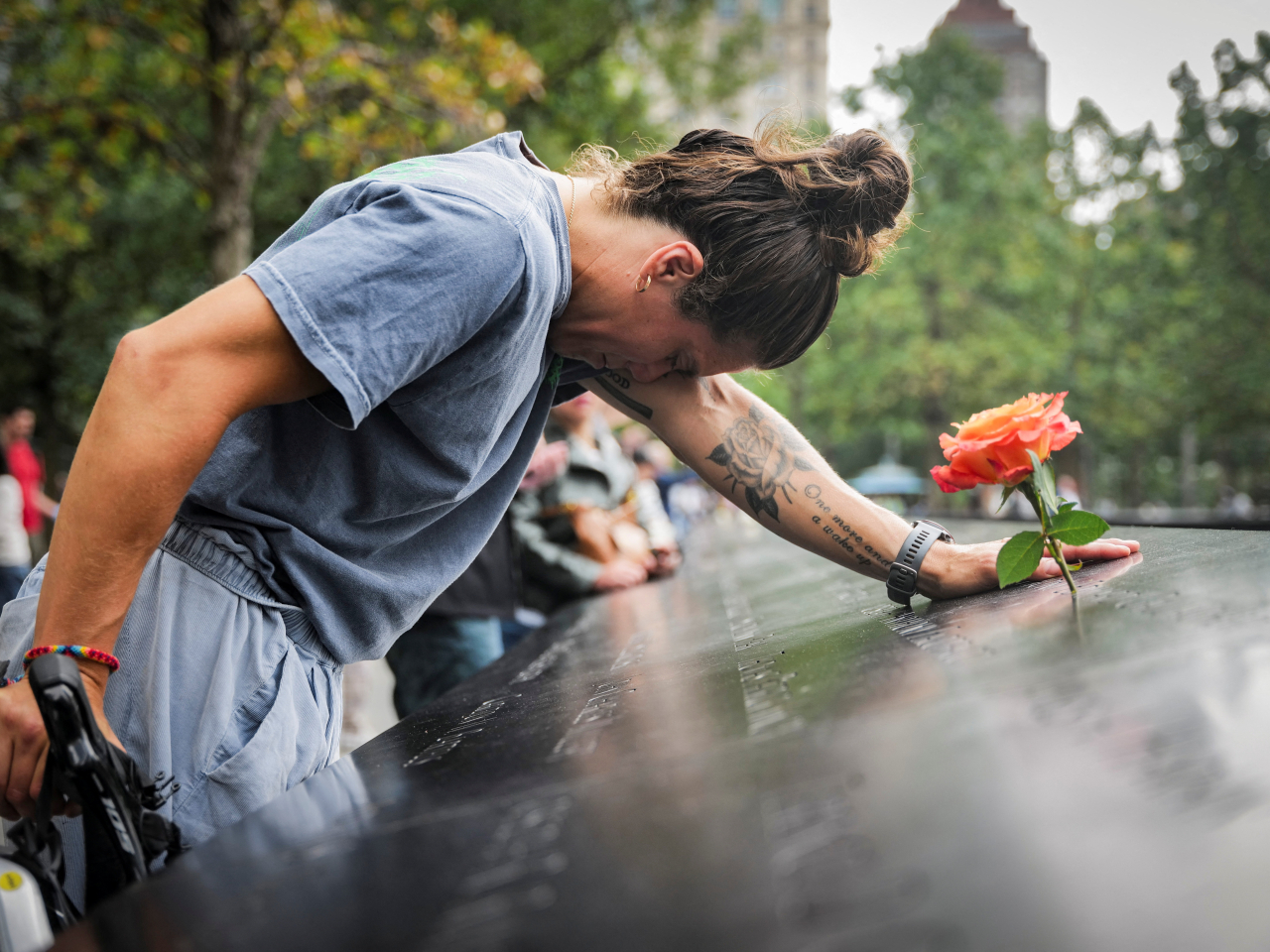 A woman remembers at the 9/11 Memorial & Museum reflecting pool in Manhattan. Photo: Reuters