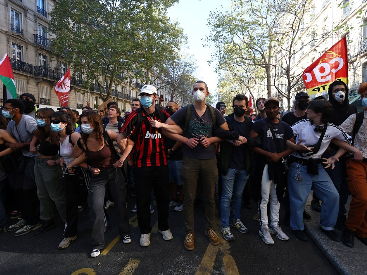 Young masked protesters lead a demonstration in Paris as part of the day of nationwide strikes and protests against the government and cuts in the next budget. Photo: Reuters