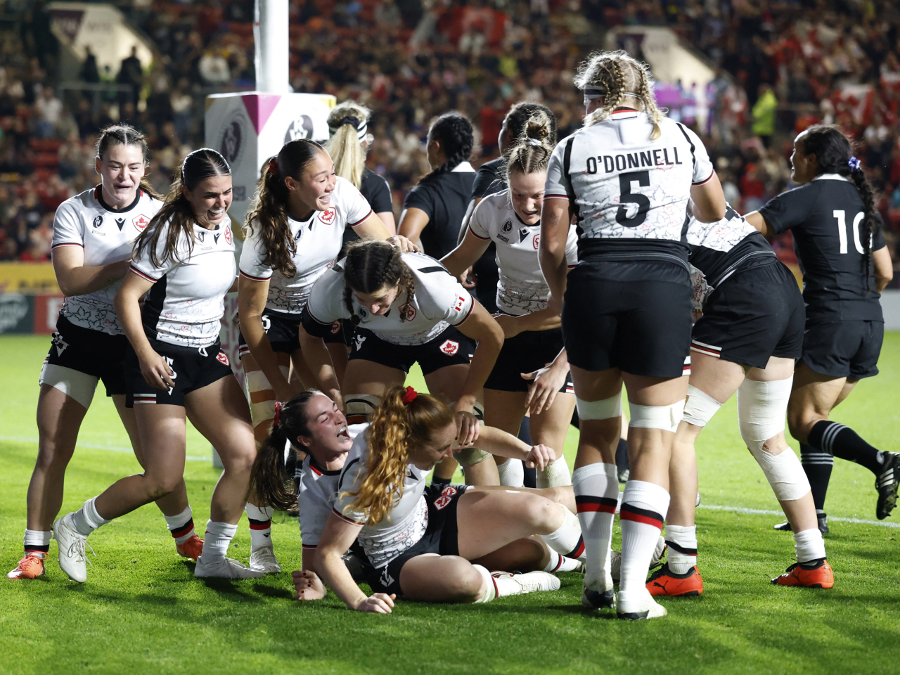 Canadian players celebrate after their fifth try against the reigning champions in Bristol. Photo: Reuters