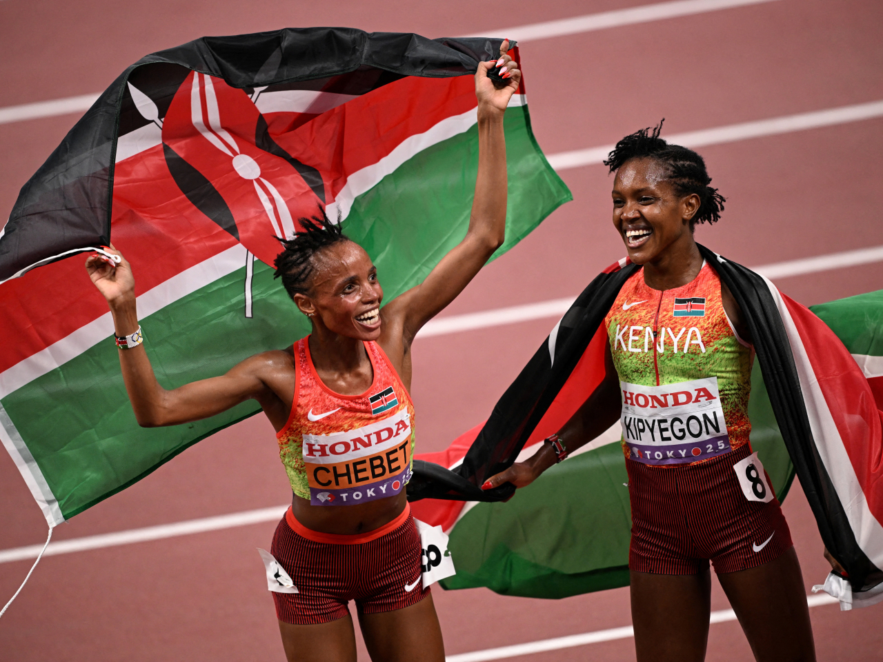 Gold medallist Beatrice Chebet celebrates with silver medallist and Kenyan compatriot Faith Kipyegon after winning the women's 5,000m. Photo: Reuters
