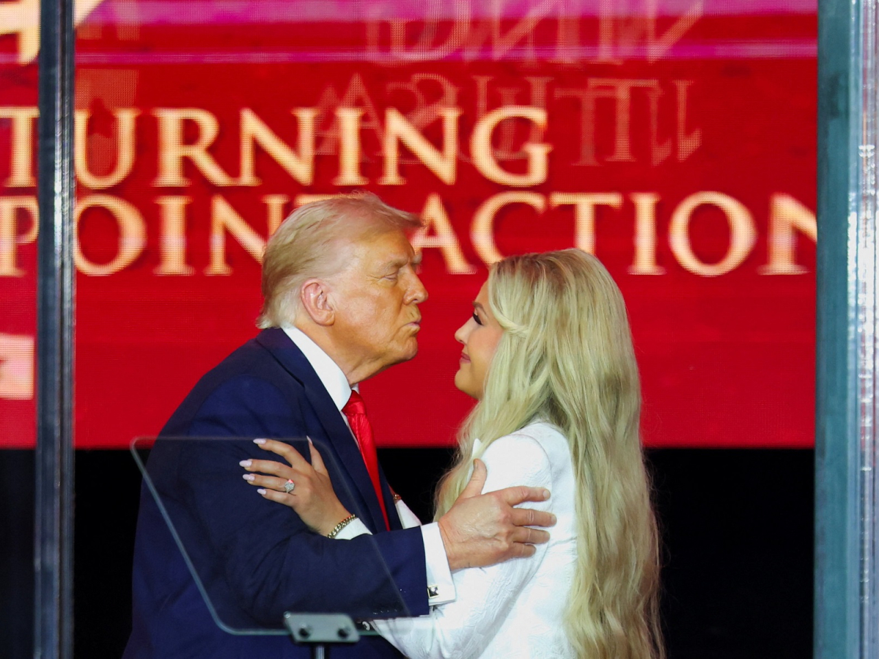 Donald Trump leans in to kiss Erika Kirk, Charlie Kirk's widow, during a memorial service for slain conservative commentator Charlie Kirk at State Farm Stadium in Glendale, Arizona. Photo: Reuters