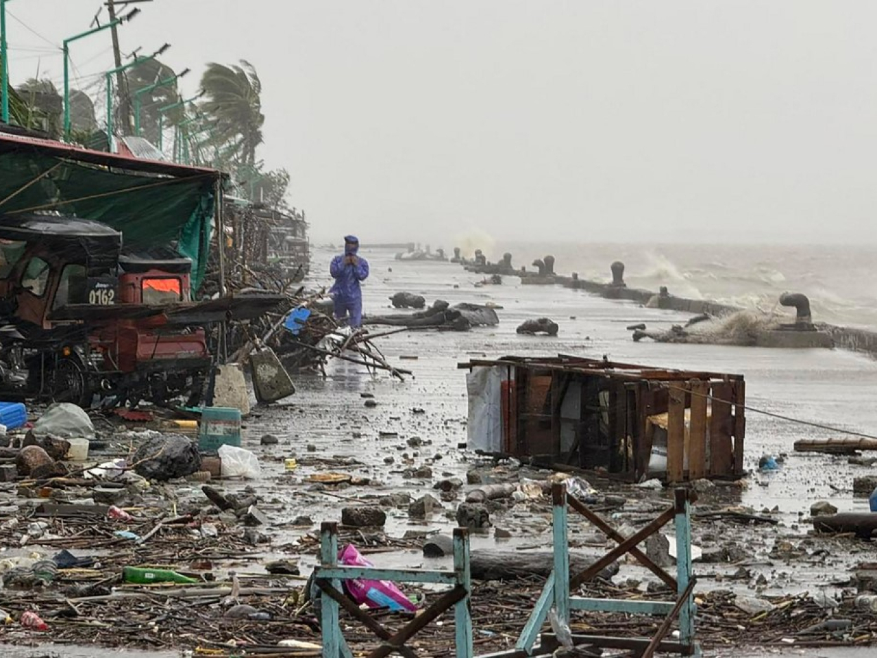 A resident of Aparri town, Cagayan, has a first-hand look at the havoc wreaked by Ragasa. Photo: AFP