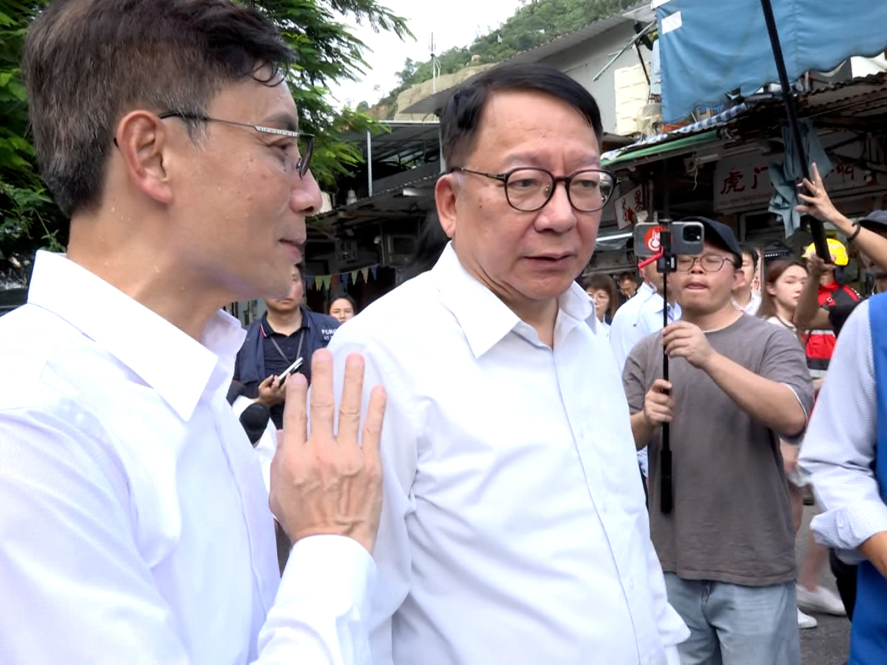 Eric Chan was briefed about the precautions taken by the Drainage Services Department in Lei Yue Mun. Photo: RTHK
