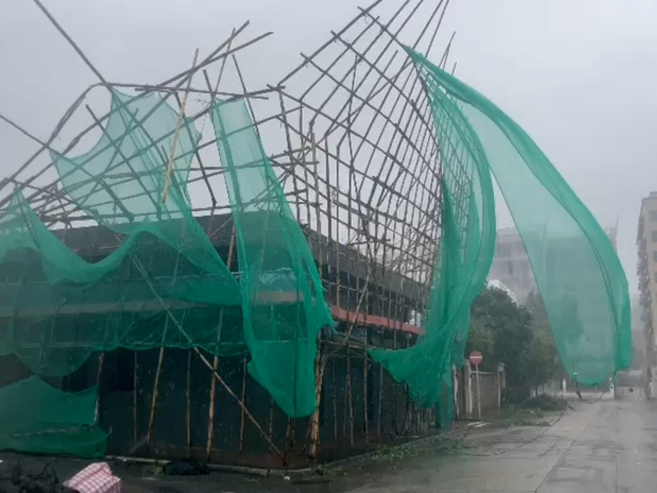 Scaffolding surrounding a Kowloon Tong building partially collapsed under Ragasa's strong winds. Photo: RTHK