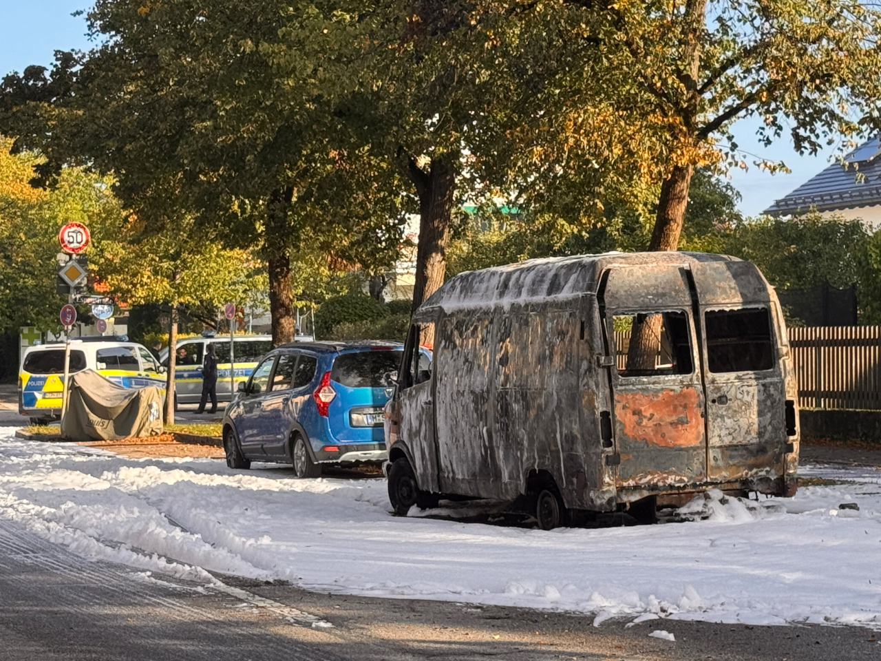 A burnt-out van is covered in foam after being extinguished by firefighters near the scene of the blast in Munich. Photo: Reuters
