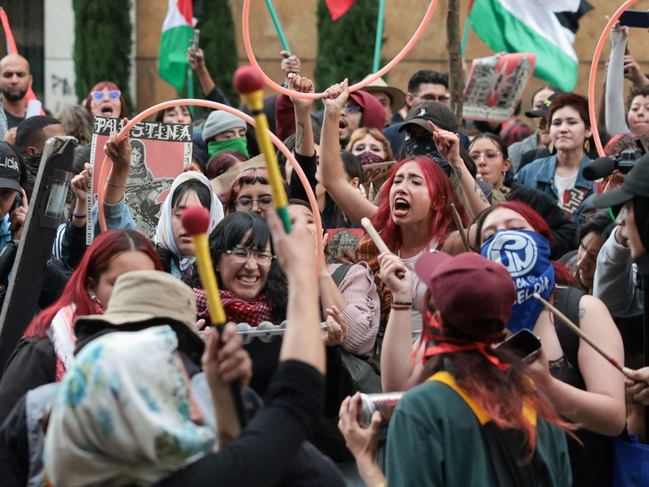 Protesters shout slogans next to police officers during a demonstration in Bogota, Colombia. Photo: Reuters
