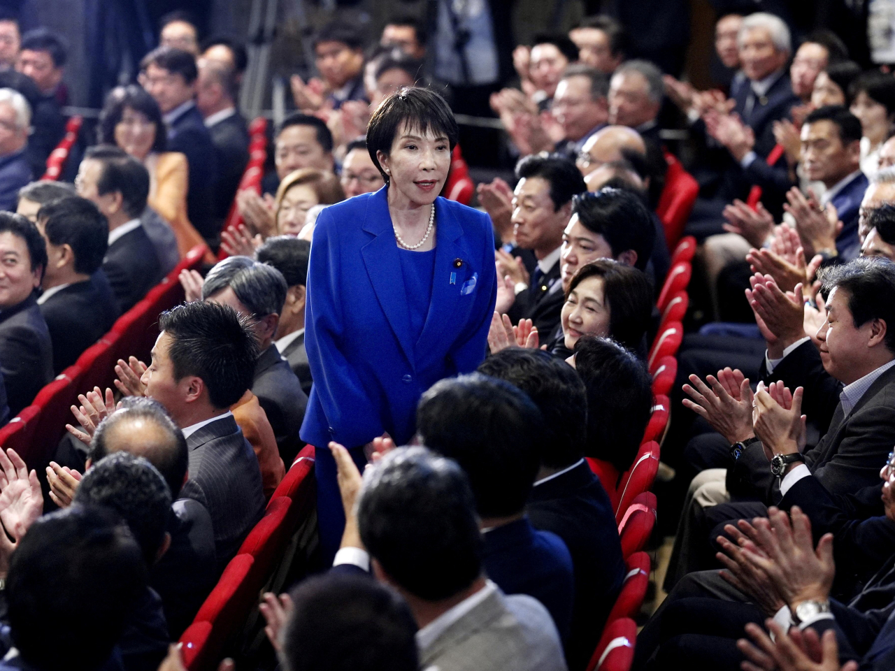Sanae Takaichi acknowledges applause from LDP lawmakers after winning the vote to lead the party. Photo: Reuters