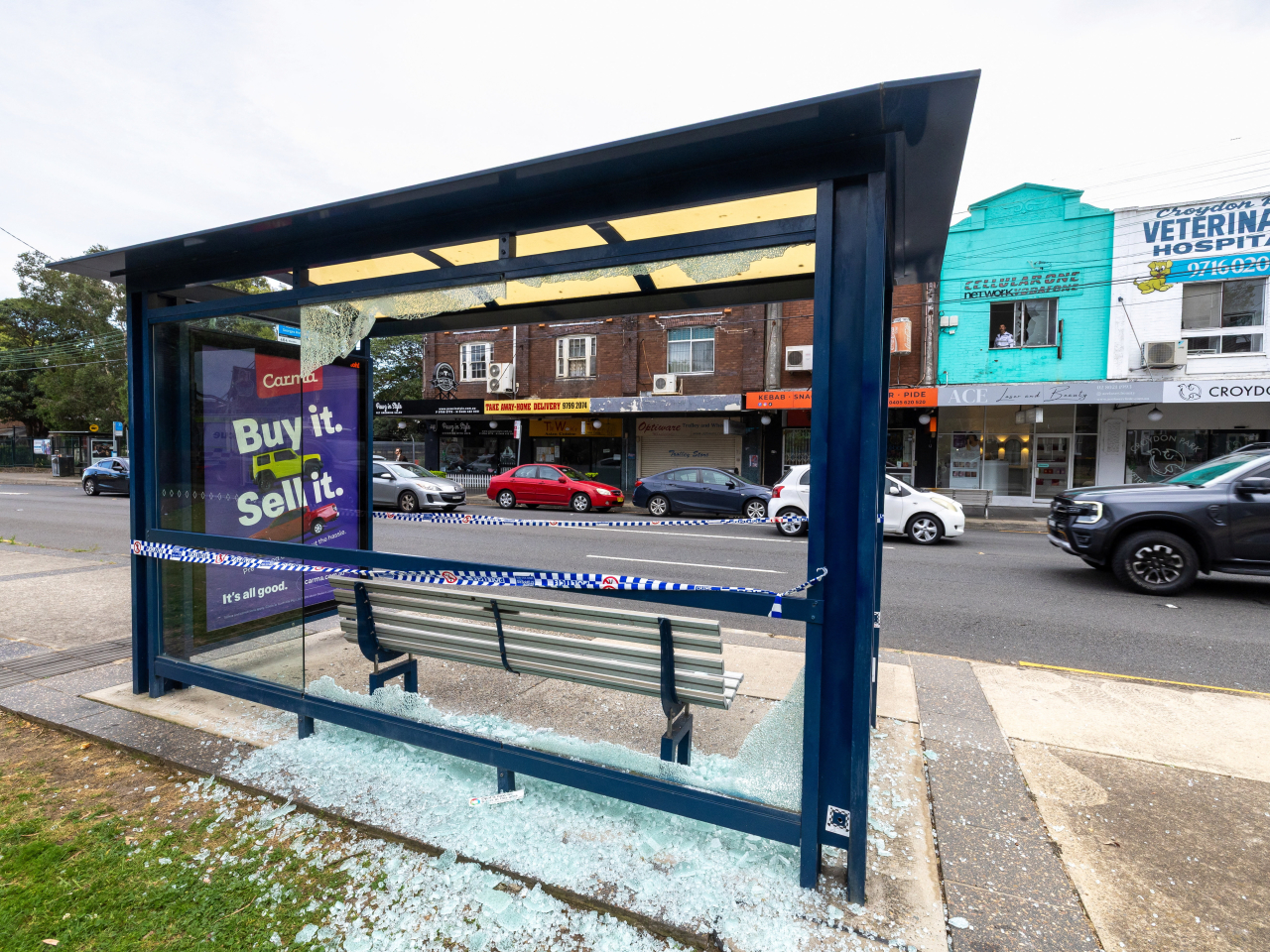 The bus stop that was one of the targets in the Croydon Park mass shooting incident is cordoned off. Photo: Reuters