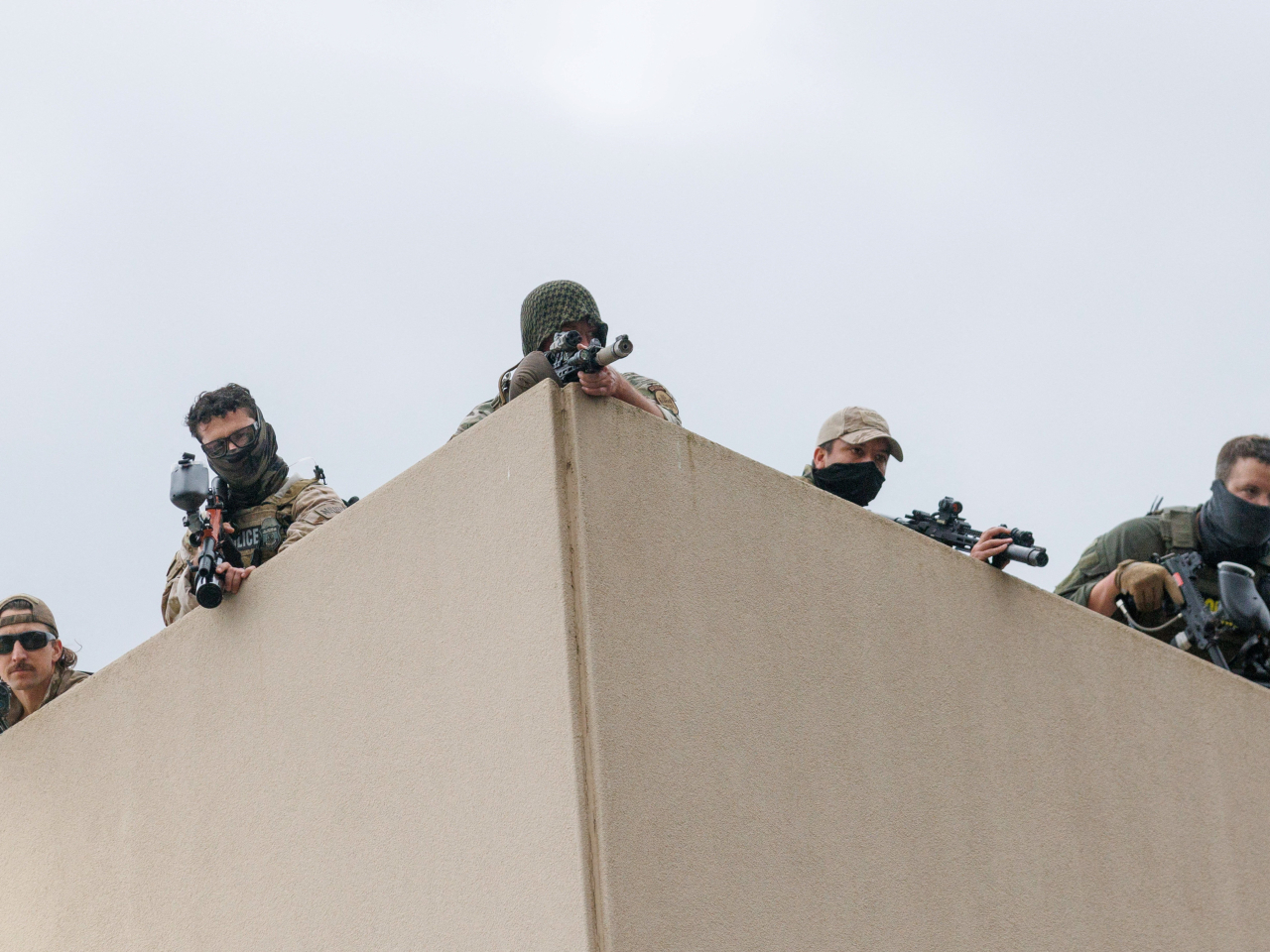 Snipers, at least three holding lethal weapons, on the roof of the Immigration and Customs Enforcement building were seen aiming their rifles at protesters in Portland. Photo: Reuters