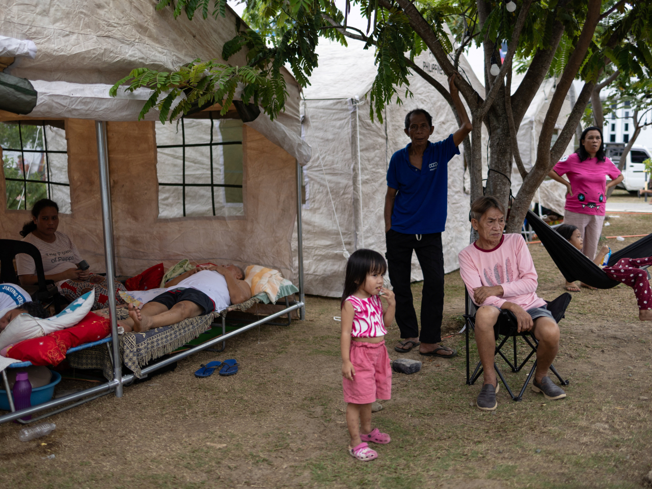 Residents of Manay, Davao Oriental, rest or ponder the way forward in wake of the 7.4 magnitude quake. Photo: Reuters