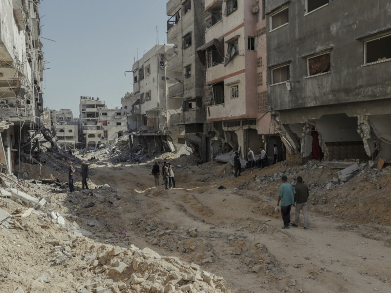 Palestinians navigate the streets in Gaza filled with rubble. Photo: AFP
