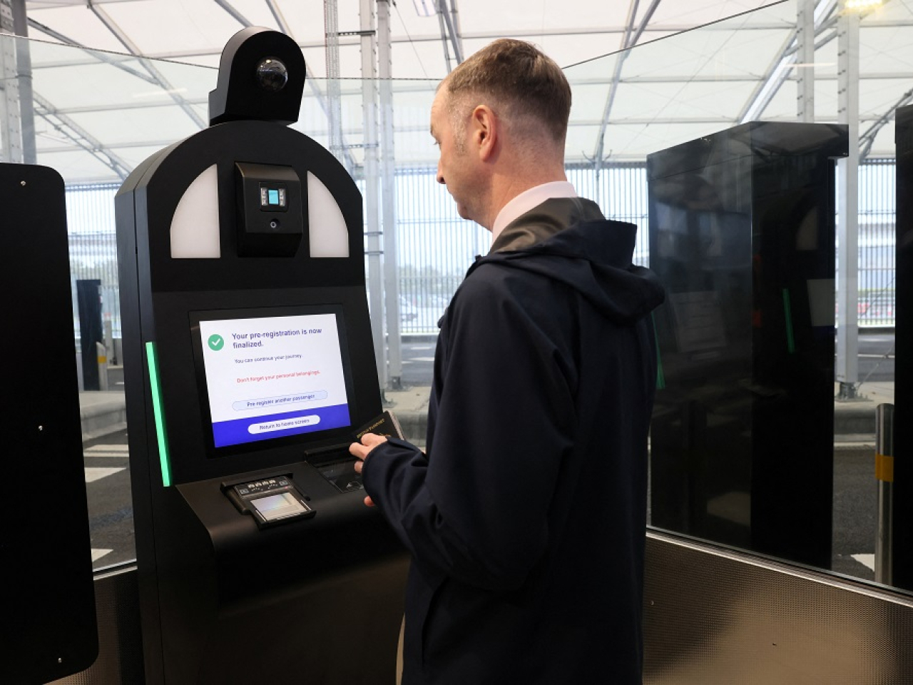 A man operates an automated EES kiosk during a demonstration of the European Union's Entry/Exit System. Photo: Reuters