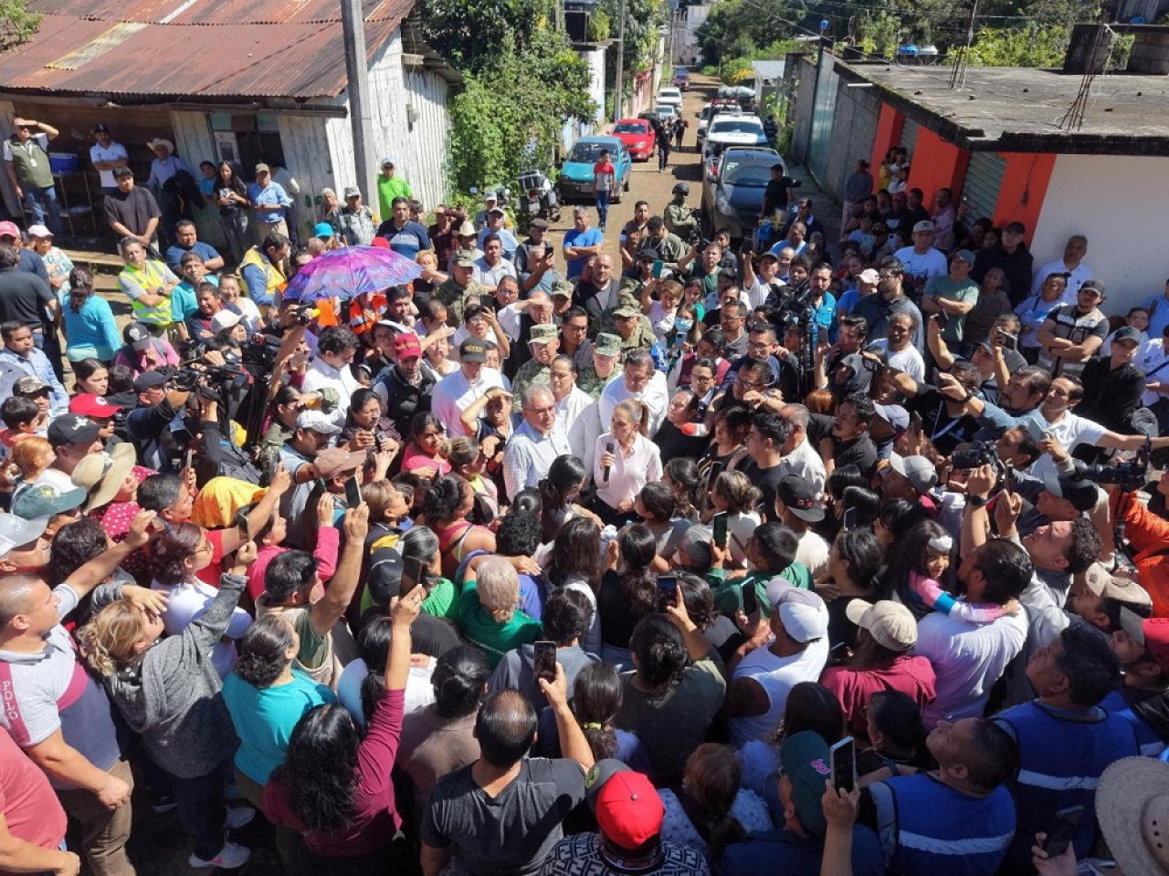 President Claudia Sheinbaum addresses residents in an area affected by the torrential rains that left scores of people dead or missing. Photo: Reuters
