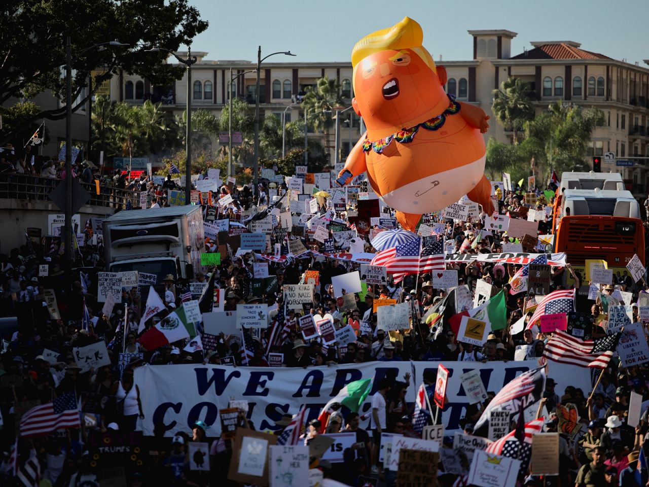 An inflatable balloon depicting Donald Trump hovers above the crowd during a "No Kings" protest  outside City Hall in Los Angeles. Photo: Reuters