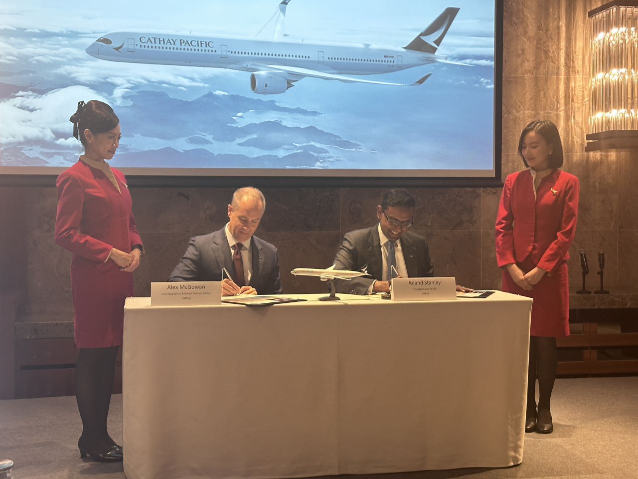 Representatives from Cathay and Airbus sign a partnership agreement to boost sustainable aviation fuel production. Photo: RTHK