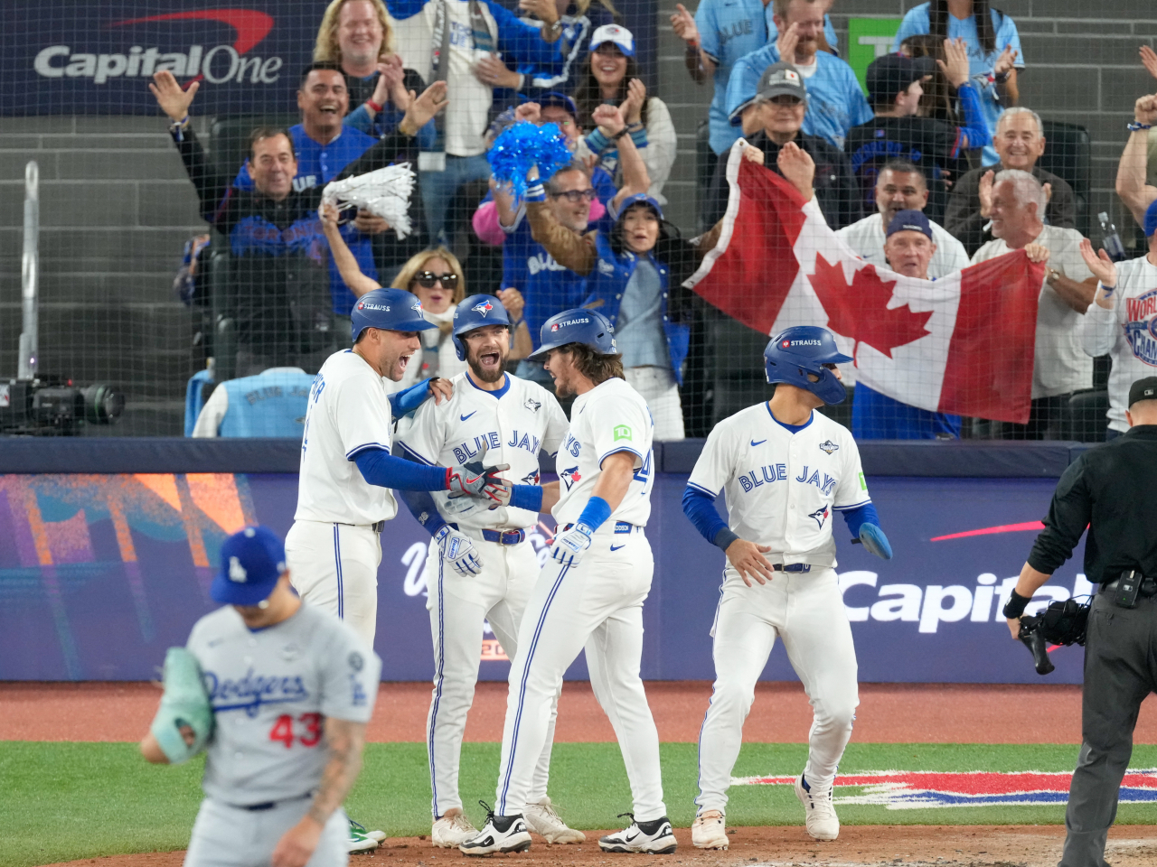 Addison Barger gets a hero's welcome at the home plate from teammates after hitting a towering grand slam. Photo: Reuters