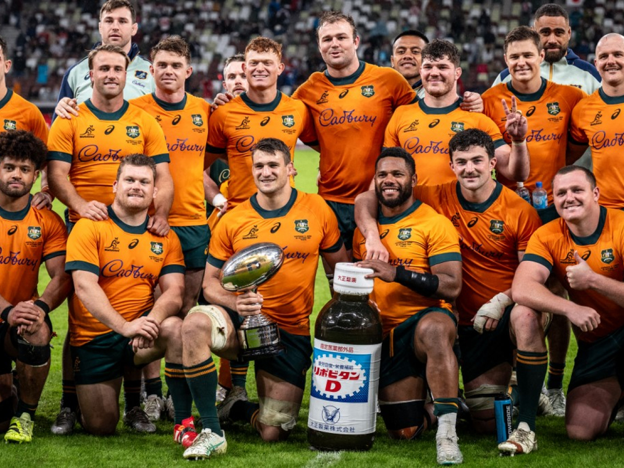 Australia players get a picture taken for their album following victory against Japan at the National Stadium in Tokyo. Photo: AFP