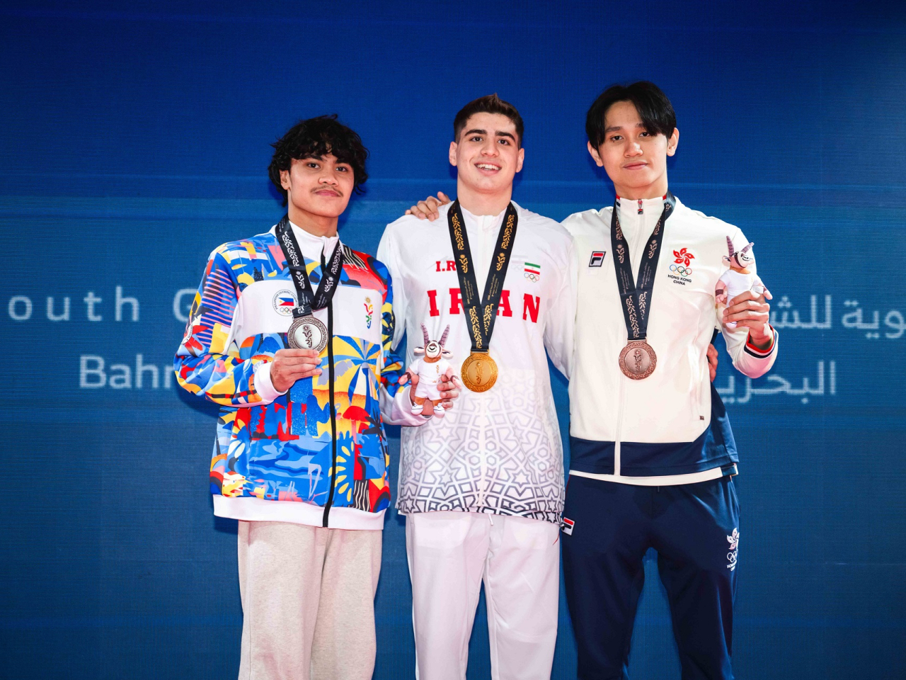 James Lau (right) was just 0.48 seconds off the pace of Iranian champion Mohammadmahdi Gholami (centre) in the boys' 100m butterfly. Photo courtesy: SF&OC of Hong Kong, China