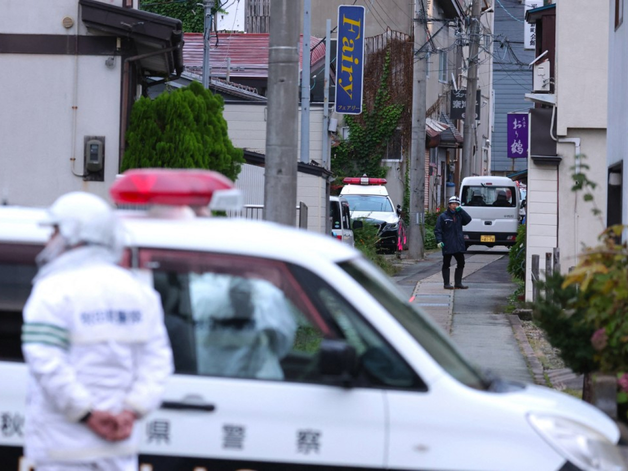 Police officers stand guard around a house where a bear is believed to have ran inside in Yuzawa City, Akita, this month. File photo: Yomiuri Shimbun/AFP