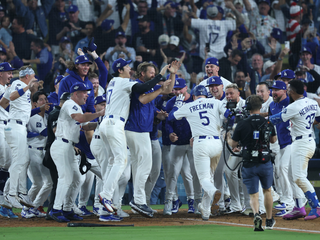 Freddie Freeman is mobbed by teammates after hitting a game-winning home run in the 18th inning against the Toronto Blue Jays at Dodger Stadium. Photo: Reuters