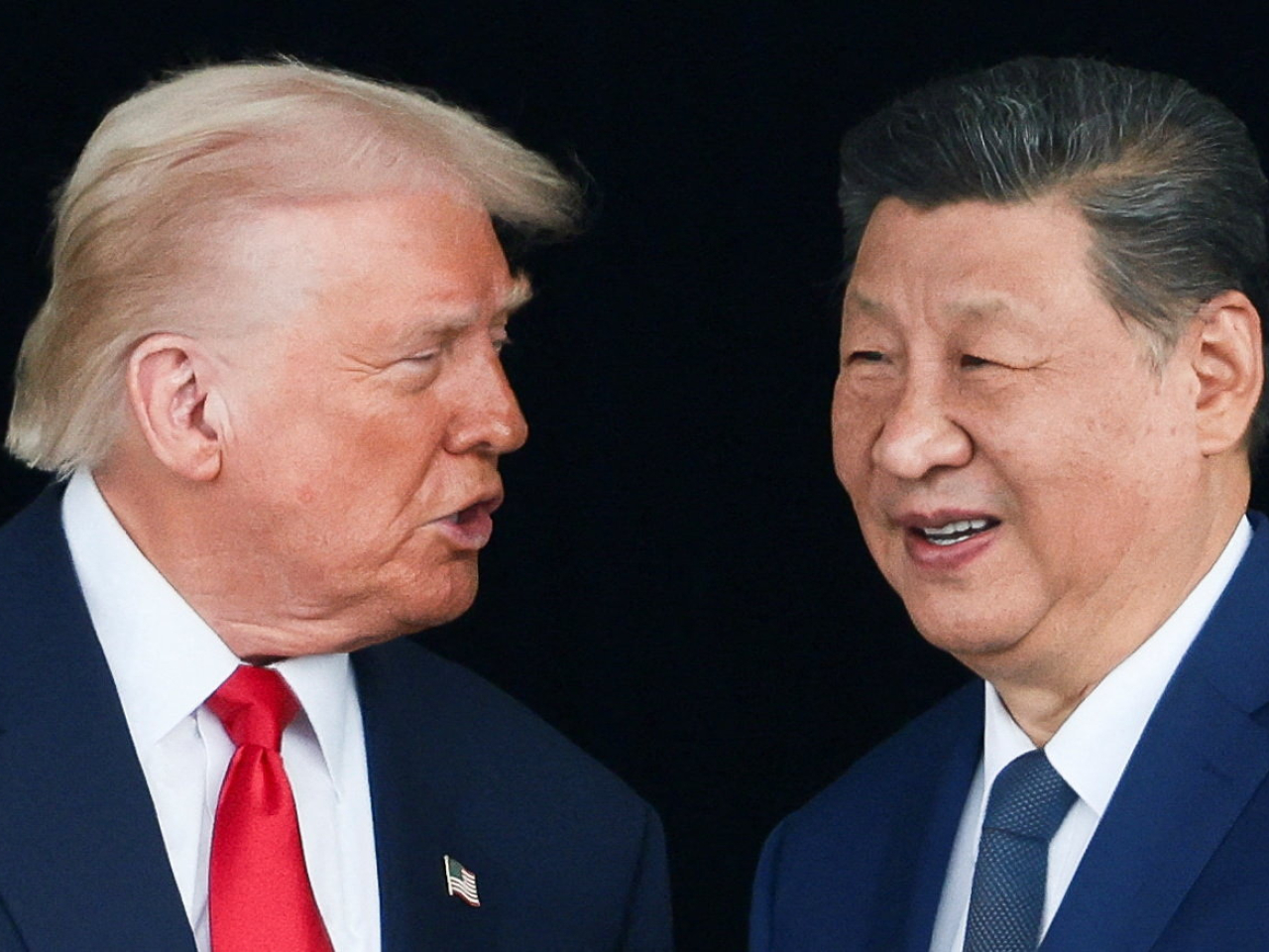 Donald Trump speaks to Xi Jinping at the end of their meeting at Gimhae Air Base. Photo: Reuters