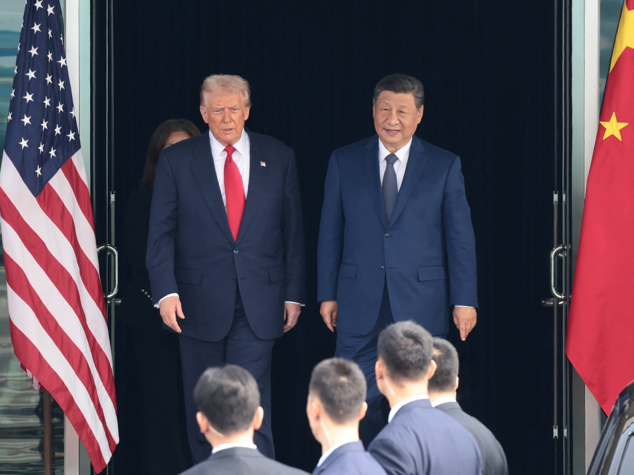 Presidents Xi Jinping and Donald Trump walk out of Gimhae International Airport at the end of their summit in Busan. Photo: Reuters