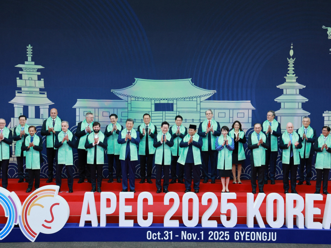Apec leaders take a group photo wearing scarves inspired by the traditional Korean hanbok. Photo: Reuters