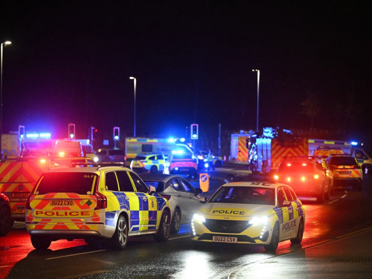 Police cars and Ambulances outside Huntingdon Station in eastern England following a stabbing on a train. Photo: AFP