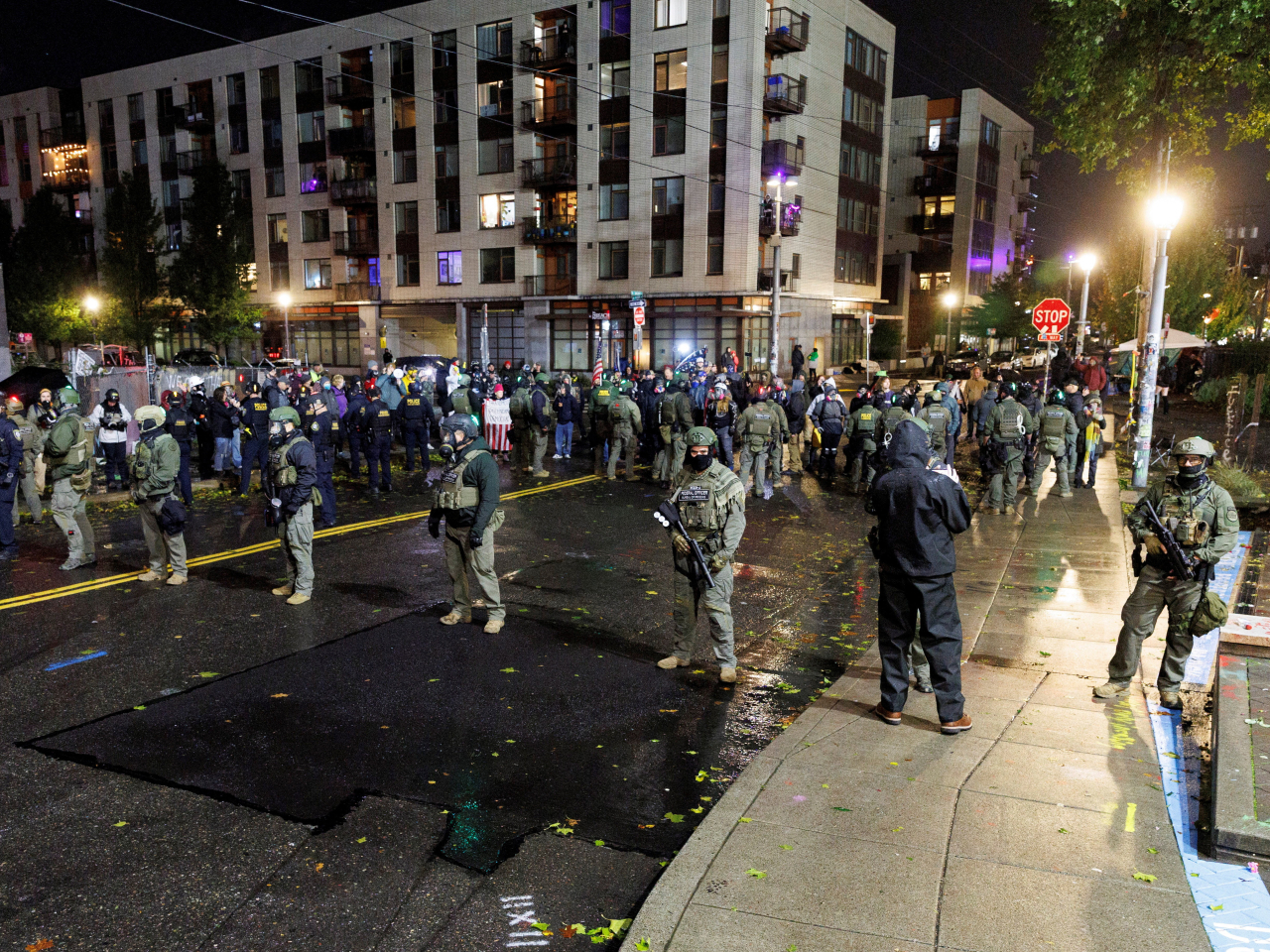 Federal officers stand guard outside an Immigration and Customs Enforcement facility in Portland amid protests and counter-protests. File photo: Reuters