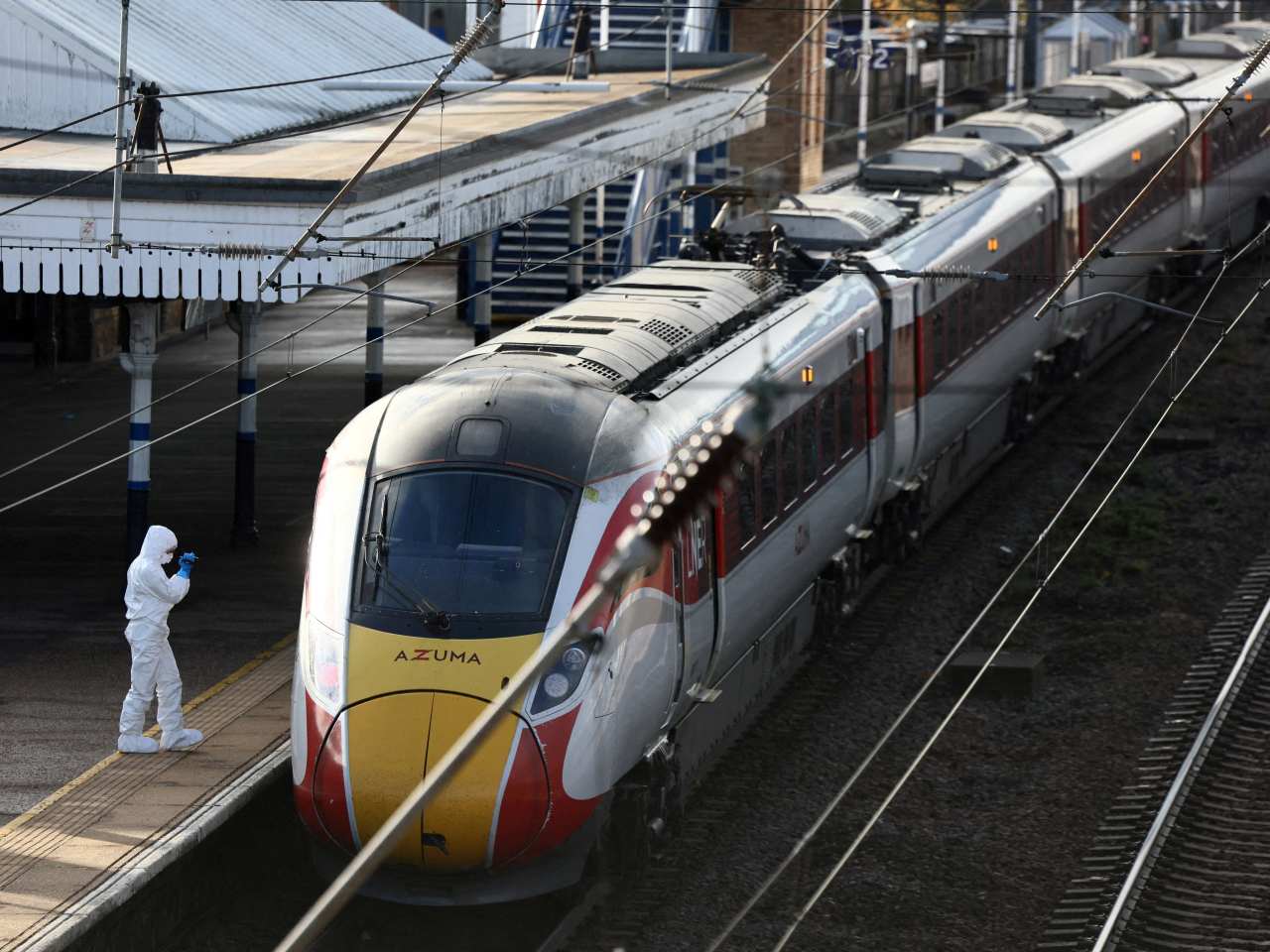 A crime-scene tech records the scene at Huntingdon station after the train made an emergency stop. Photo: Reuters