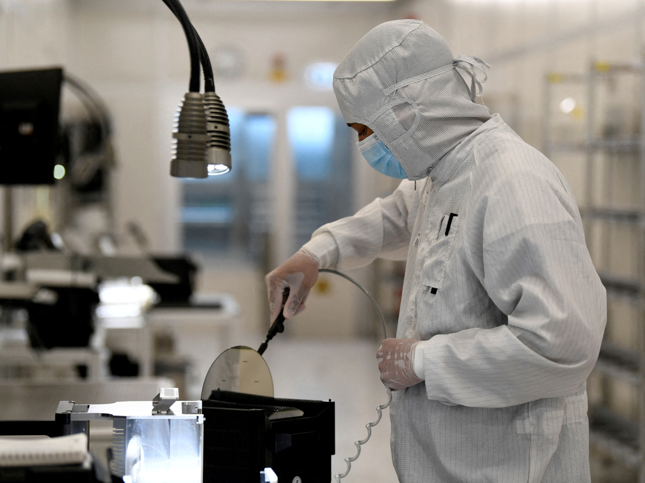 An employee works with a wafer on a production line of Nexperia's plant in Hamburg, Germany. File photo: Reuters