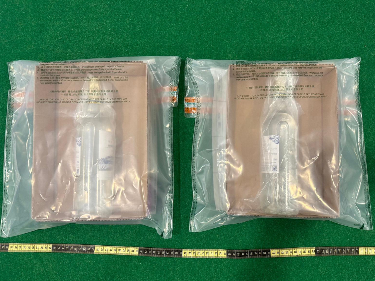 Customs officers seized 1.5 kilos of a substance they suspect to be liquid methamphetine inside wine bottles allegedly stashed in a passenger's suitcase. Photo courtesy of Customs and Excise Department
