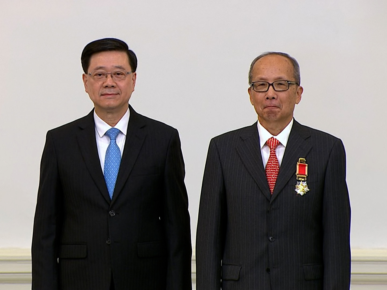 John Lee (left) presents awards and honours to people recognised in this year’s Honours List. Photo: