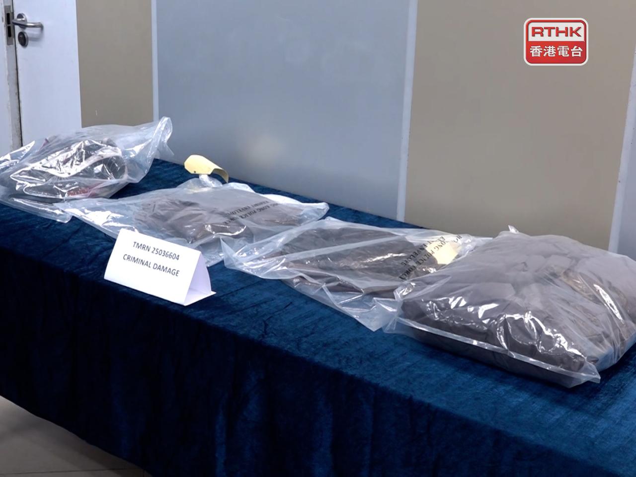 Police display the damaged campaign flags belonging to three Legco candidates. Photo: RTHK