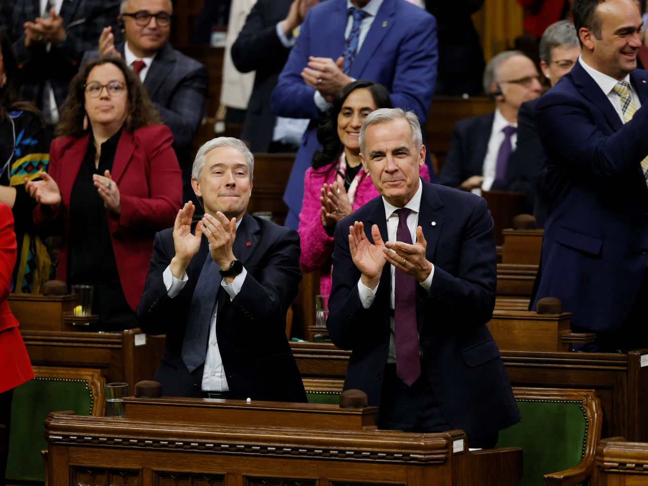 Mark Carney, right, and finance minister Francois-Philippe Champagne are all smiles after the budget narrowly passes in the House of Commons. Photo: Reuters