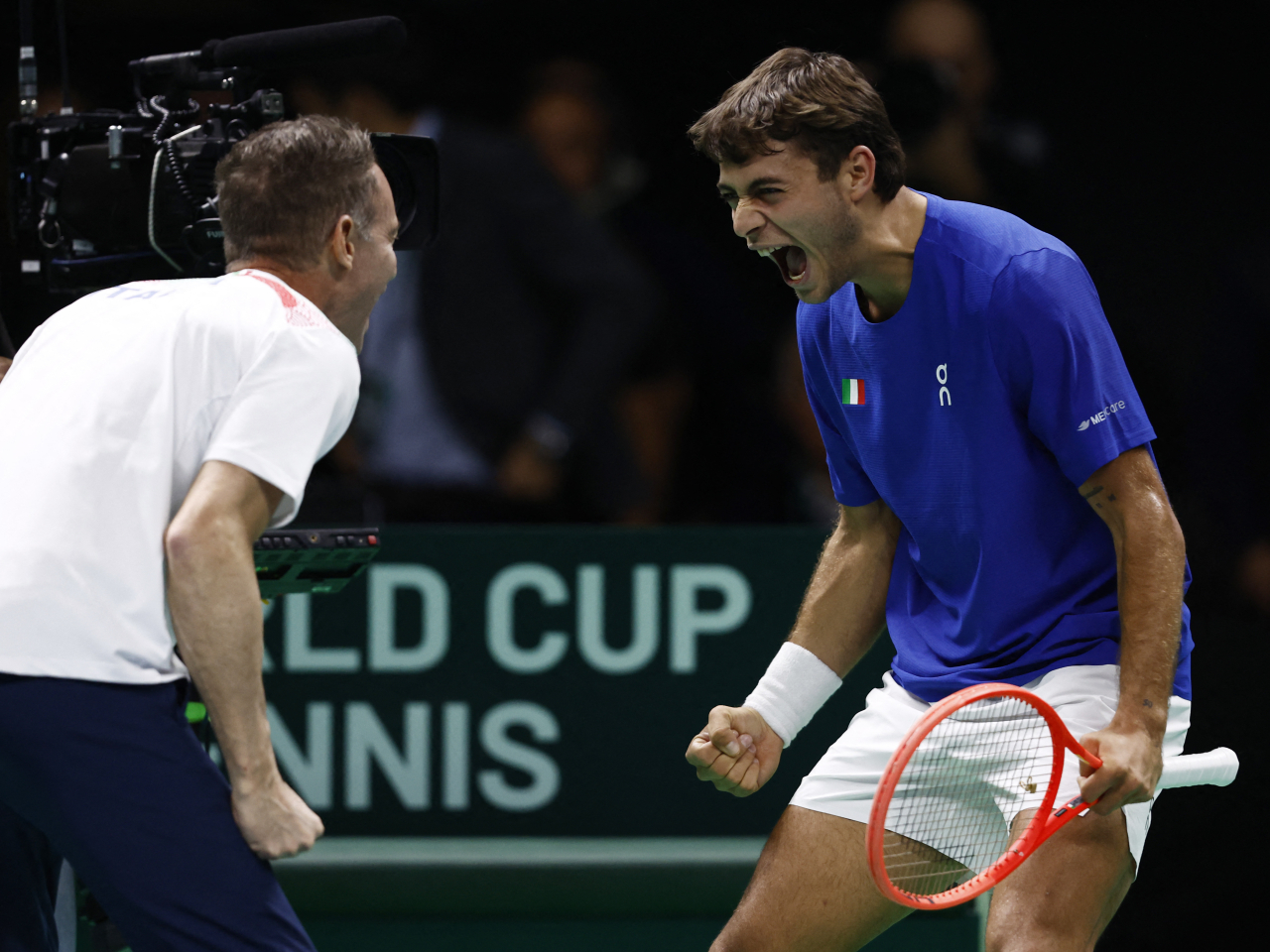 Flavio Cobolli, right, swept past Austria's Filip Misolic to seal Italy's place in the next stage. Photo: Reuters
