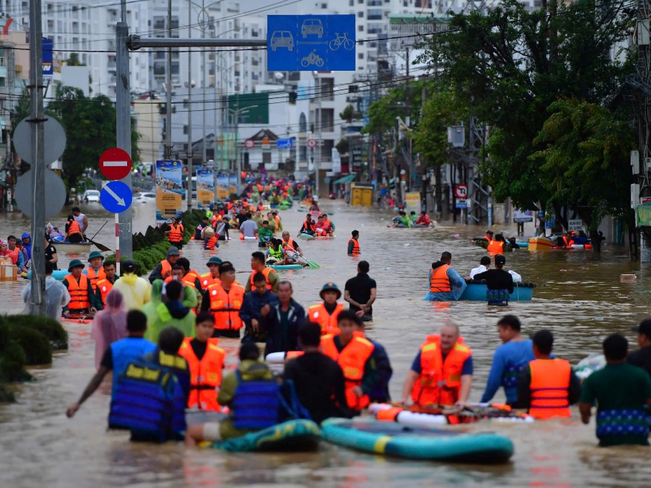 Vietnamese in Nha Trang, Khanh Hoa province, wade through floodwaters that beset whole city blocks. Photo: AFP