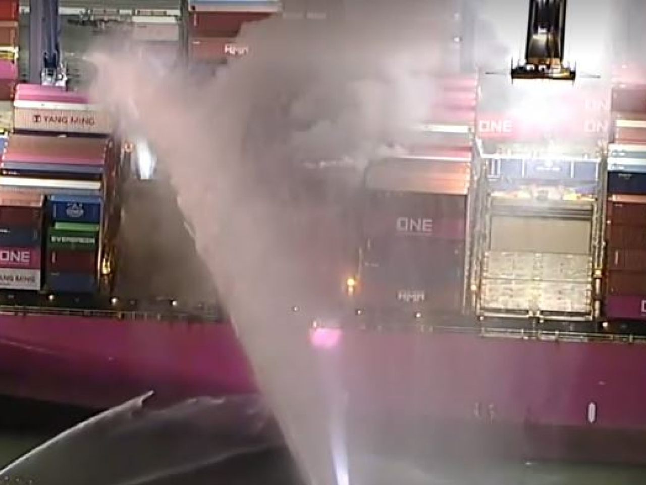 Marine fire-fighting units cool the ship's exterior at San Pedro port. Photo: Reuters