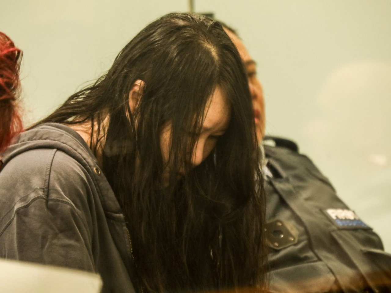 Hakyung Lee looks down as a New Zealand court sentenced her to life in prison for the murder of her two children. Photo: AFP