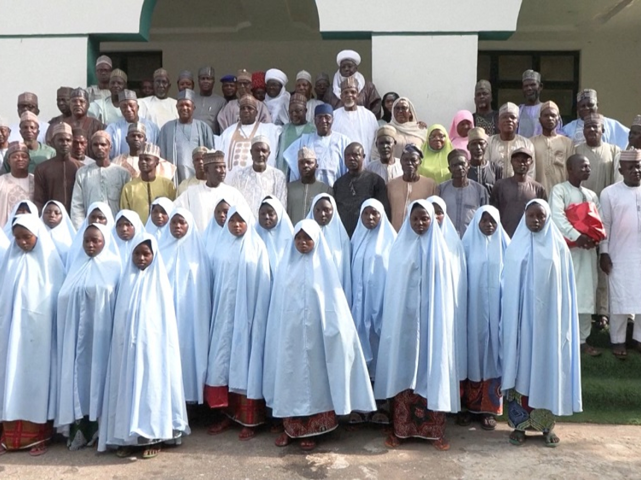 Girls freed from captivity in northwestern Kebbi state pose with parents and officials. Photo: Reuters