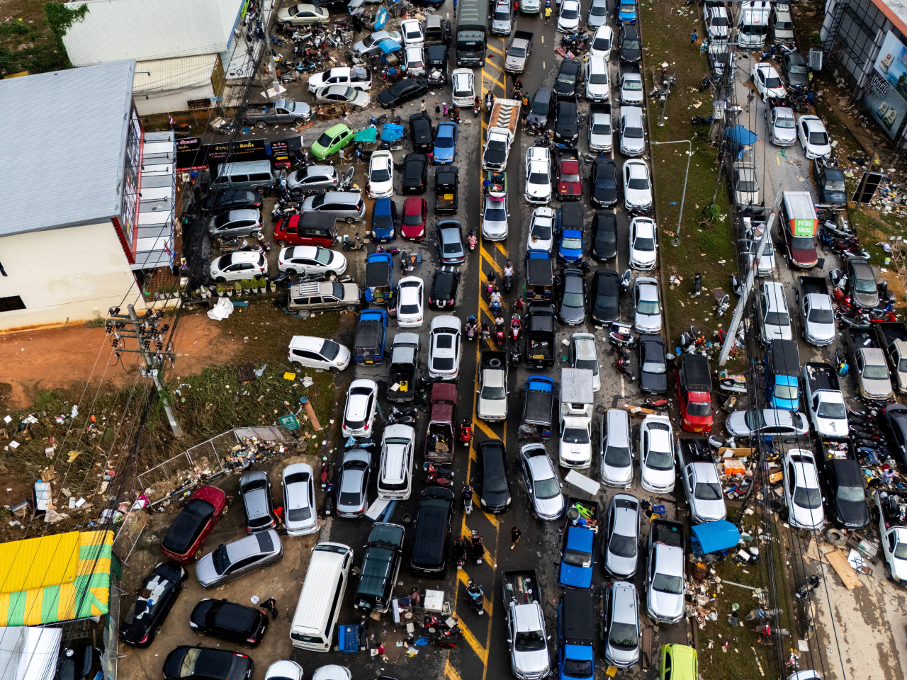 Cars are parked on a road to escape the floodwaters in Hat Yai district, Songkhla province. Photo: Reuters