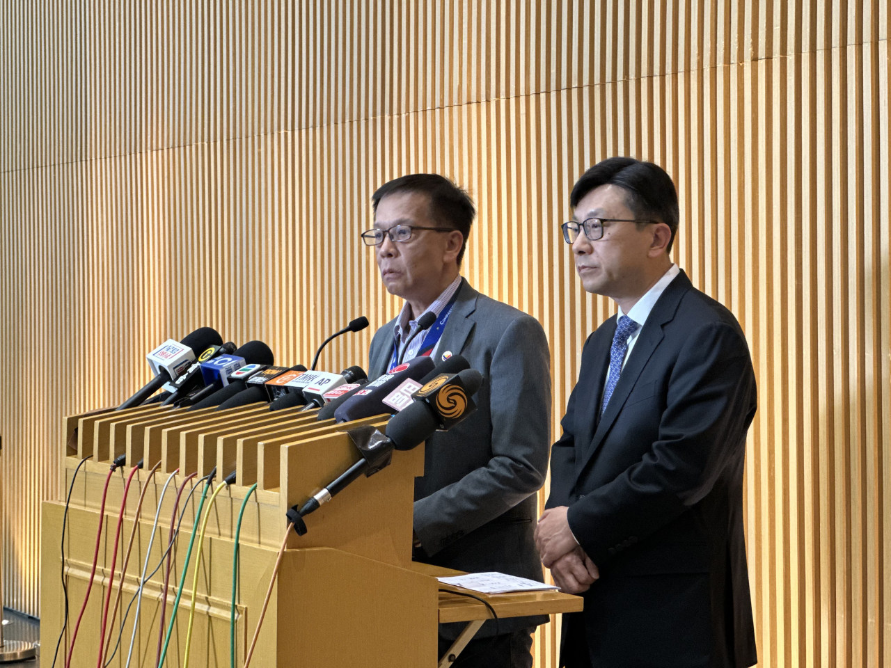 Labour and welfare chief Chris Sun (right) has pledged to ensure only the genuine family members of the domestic helpers killed are eligible to claim the financial assistance. Photo: RTHK