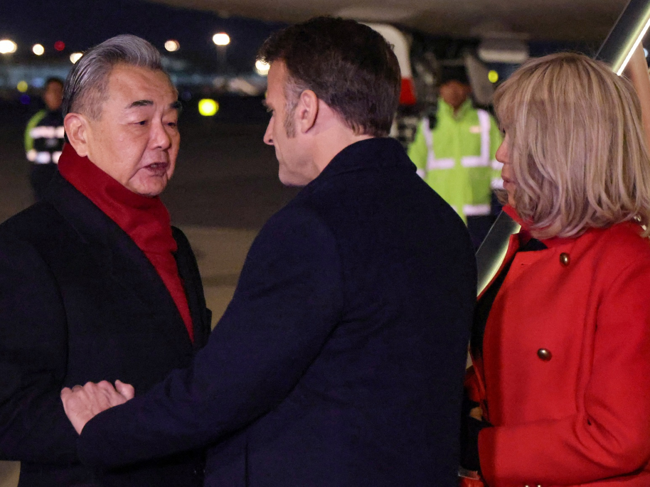 Foreign Minister Wang Yi, left, welcomes Emmanuel Macron and his wife Brigitte at Beijing Capital International Airport. Photo: Reuters