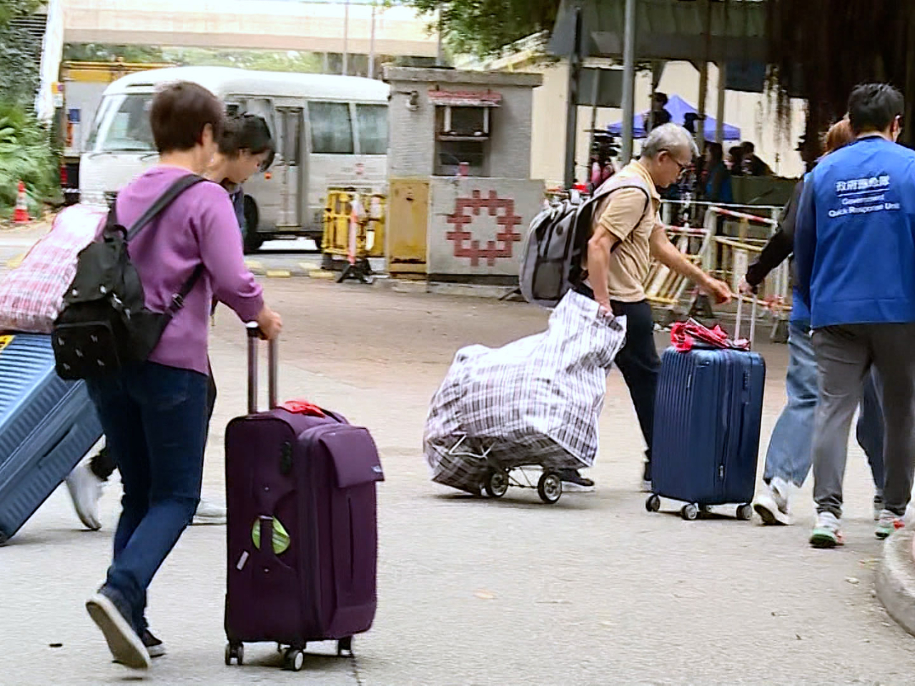 居民陸續帶同行李箱到場，取回貴重物品。（張連登攝）