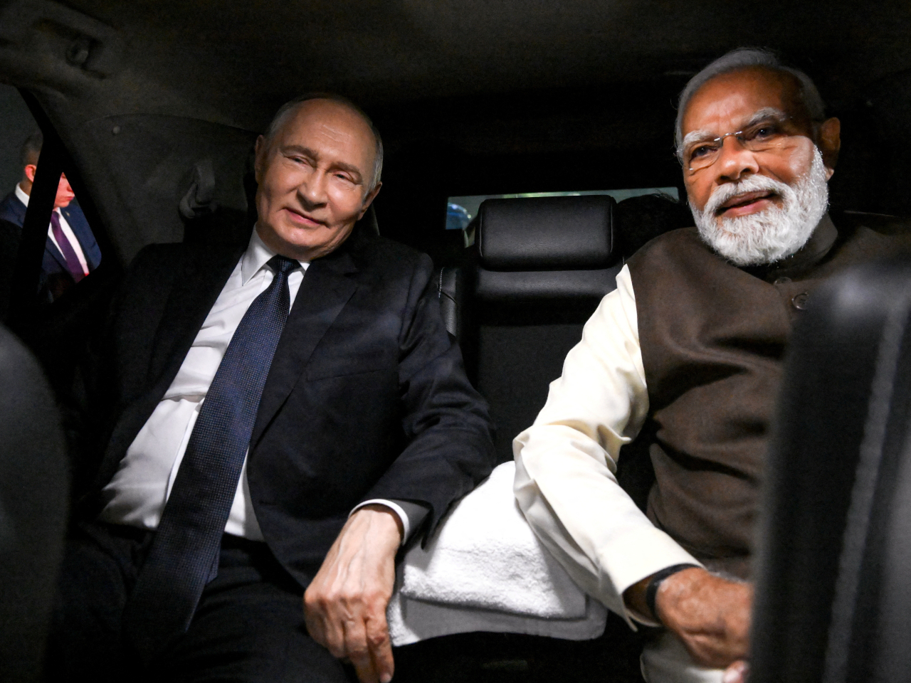 Vladimir Putin and Narendra Modi ride in a limousine following a welcoming ceremony at Palam Air Base in New Delhi. Photo: Reuters