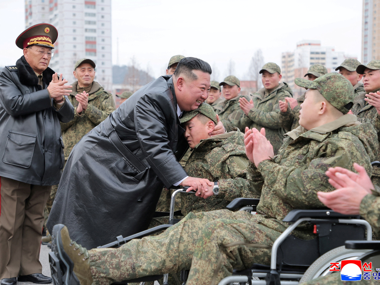 Kim Jong-un hugs a soldier wounded during mine-clearing operations in Kursk in a Pyongyang ceremony. Photo: Reuters