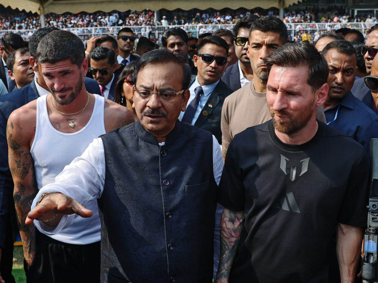 Lionel Messi is surrounded by players and officials at Salt Lake stadium in Kolkata in a move that raised the hackles of fans who paid thousands of rupees. Photo: Reuters