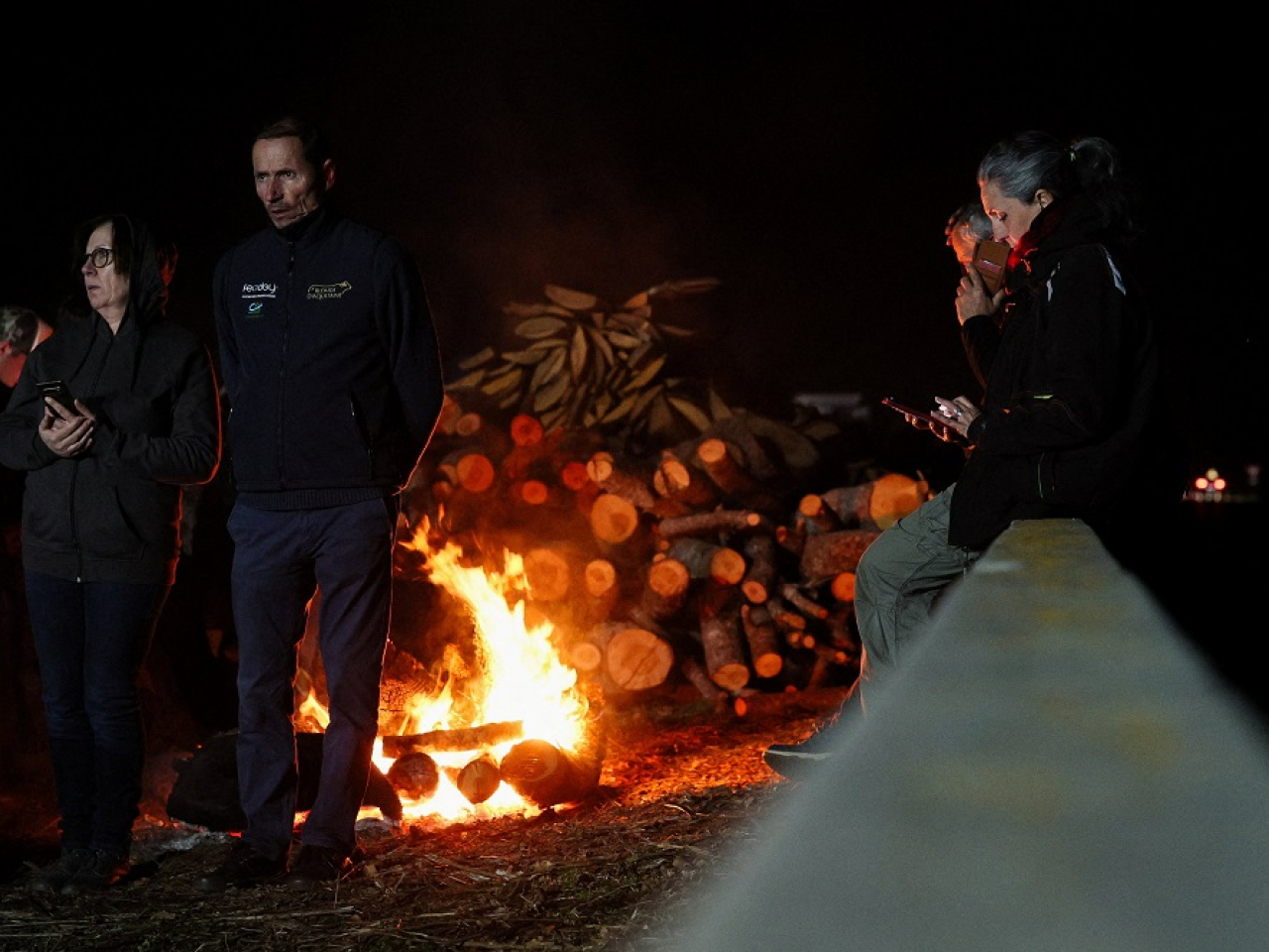Farmers keep warm at the A64 motorway blockade site near Carbonne. Photo: Reuters