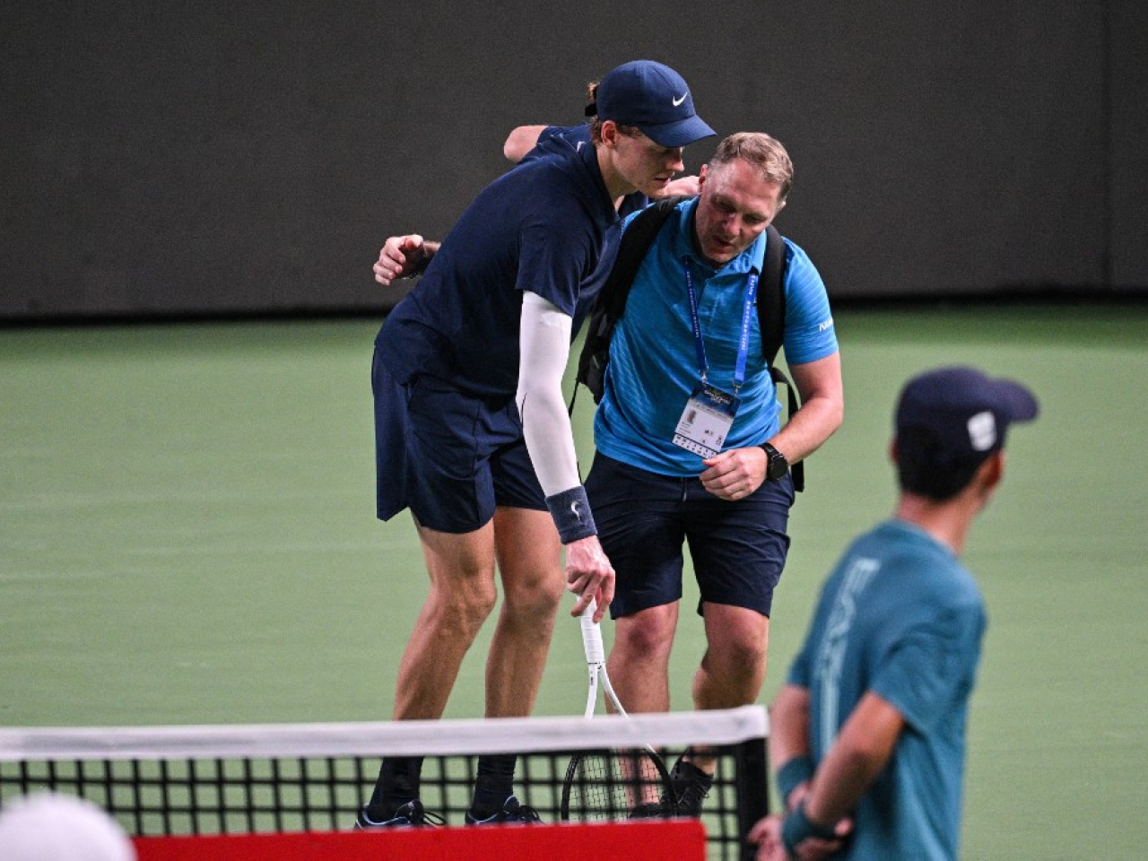 Jannik Sinner is helped by a trainer during his match against Tallon Griekspoor at the Shanghai Masters in October amid stifling humidity. File photo: AFP
