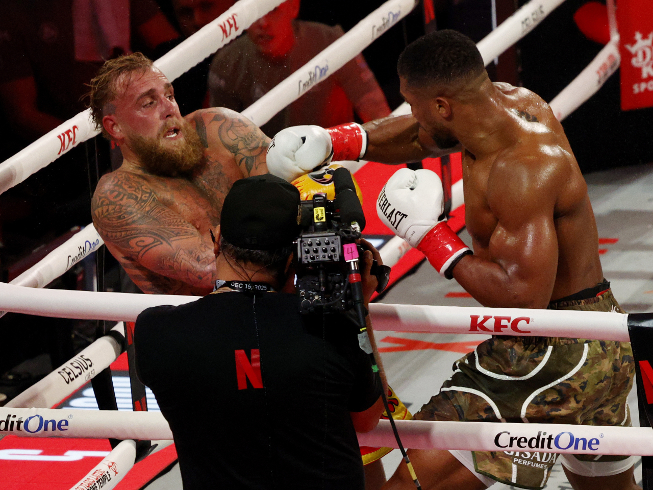 YouTuber-turned-boxer Jake Paul is on the ropes as he tries to keep former world heavyweight champion Anthony Joshua at arm's length. Photo: Reuters
